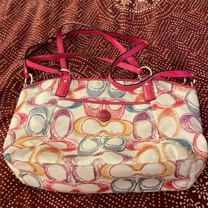 Coach Scribble tote with poppy red/pink handles.